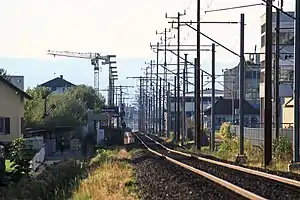 Small platform surrounded by buildings and overhead wires