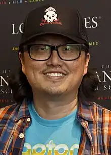  A picture of an Asian man who wears glasses and smilles.