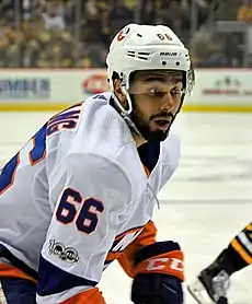 Young man wearing hockey jersey and helmet