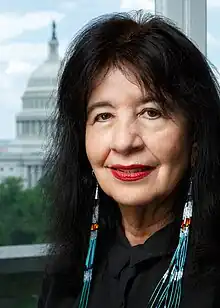 Harjo smiling, wearing traditional earrings