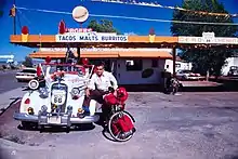 picture of Juan Delgadillo standing next to his 1936 Chevrolet