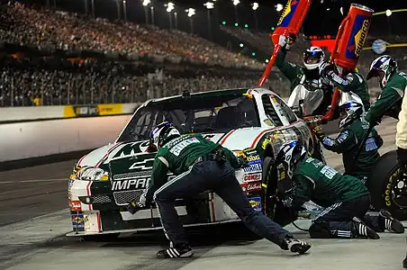 Image 17Pit stopPhoto: United States National GuardDale Earnhardt, Jr.'s Hendrick Motorsports pit crew execute a pit stop at a Sprint Cup Series competition at Darlington Raceway, South Carolina, in May 2008. In motor sport, pit stops are when the racing vehicle gets more fuel, new wheels, repairs, mechanical adjustments, a driver change, or any combination of the above.More selected pictures