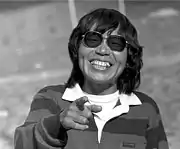 Image of a Japanese woman wearing sunglasses and laughing