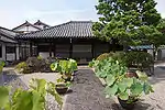 Small wooden building with white walls.