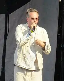 A color picture of American musician Justin Tranter performing live in 2018.