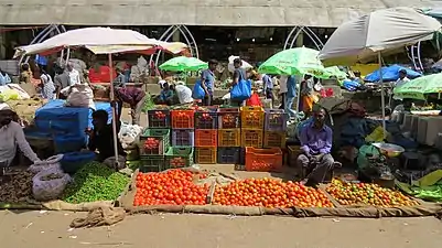 Tomato seller in the open-air section