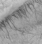 Gullies on one wall of Kaiser Crater.  Gullies usually are found in only one wall of a crater.