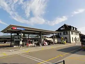 Two-story station building with hip roof and adjoining canopied platform