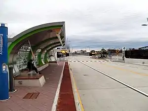 A curved shelter on a bus station platform