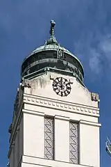 Belltower. Clock numbers are replaced by letters, reading "tempus fugit" (Latin: time flies).