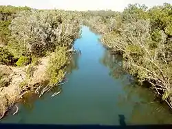 A line of still water with bush on both sides