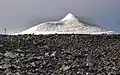 The peak glacier seen from the trail, rising from a nearly flat plateau.