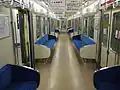 The interior of intermediate car 865 with longitudinal seating in July 2014