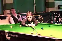 Ken Doherty playing a shot with the rest