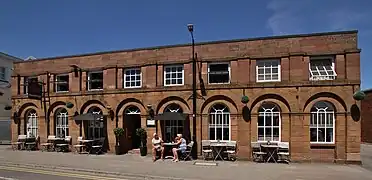 The remaining facade of the 1844 station, dismantled in 1884, reused on the Kings Arms assembly rooms on Station Road.