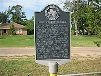 Historical marker gives a short biography of the town's namesake, Methodist preacher John Wesley Kenney.