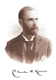 Photograph of a middle-aged man with a beard and moustache, wearing a coat and tie. The signature "Charles H. Kerr" appears beneath the photo.