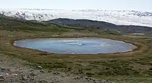 Kettle (round glacial eye-shaped lake), highlands of Isunngua, Greenland.