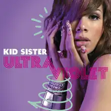 An image of a woman against a purple background, with part of her hair covering the right eye. The artist's name and album title appear on the cover, colored in white and magenta.