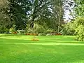 Lawns and flowerbeds at the driveway entrance.