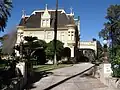 Driveway to porte-cochere and principal entrance at the architectural rear of the house.