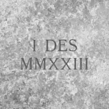 The words "I Des" carved in stone, with "MMXXIII" (2023) carved below it