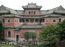 Internal courtyard of the mansion, looking North, showing the three-sided veranda on the first floor and the building's swooping green rooflines