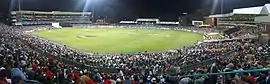 A panoramic view of a crowded sports stadium at night