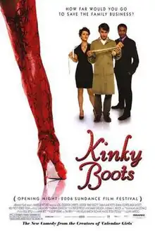 A long thigh-high red boot, fills the foreground on the left, three people stand in the distance on the back right