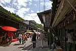 Small street lined by wooden two-storeyed houses.