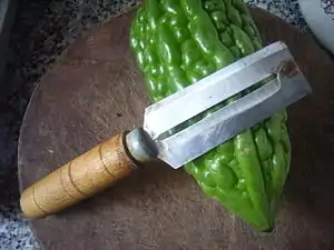 A fixed blade straight peeler aka sugarcane/pineapple peeler common in Asia