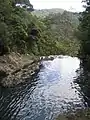 From this upper swimming hole, water cascades down 40 m before a final descent of 40 m over the three tiers.