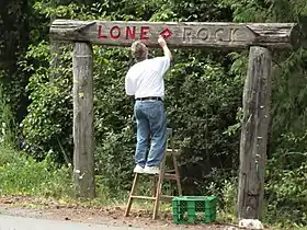 The Lone Rock community sign gets a touch-up. The corner of Anderson Hill Road and Seabeck Highway, 2 August 2011