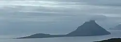 Koltur as seen from Streymoy, with the mountain of Kolturshamar centre right