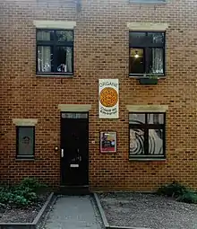 A doorway of a student flat with the logo of the ORGANE organisation on the wall