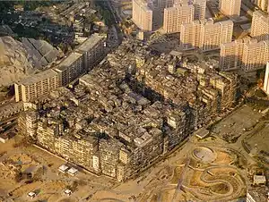 Image 7By 1990, the Kowloon Walled City contained 50,000 residents within its 2.6-hectare (6.4-acre) borders. (from History of Hong Kong)