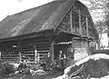 Roofed double hayrack with shed