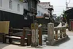 Wooden houses with white upper stories.