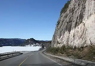 Norwegian National Road 41 passing between steep cliffs and the lake Kviteseidvatnet