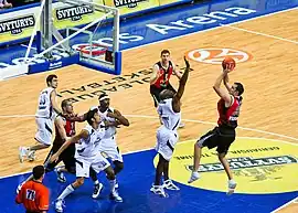 Professional basketball game, with a player preparing to shoot