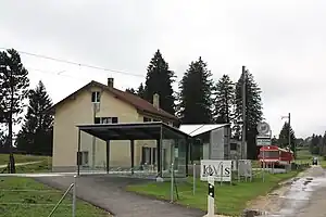 Canopy-covered shelter in front of two-story building