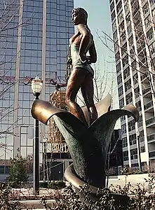 Outdoor statue of a woman standing on a lily