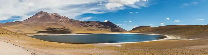 Photo of a blue lake among unvegetated mountains