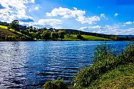 Lake with rolling, wooded hills on the opposite shore