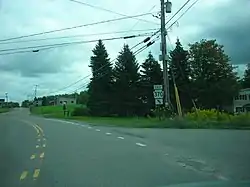 Image of a paved, marked road, flanked by greenery on both sides. A sign in the center of the photo reads "EAST 370."