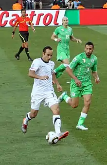 Landon Donovan keeping the ball away from an opposing player