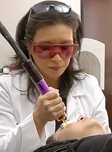 Doctor performing treatment for melasma with KTP laser