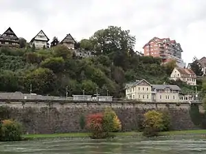 Two-story building overlooking ledge next to river