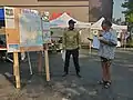 Firefighter talks with community members at the Mount Shasta Farmer's Market on July 30, 2021