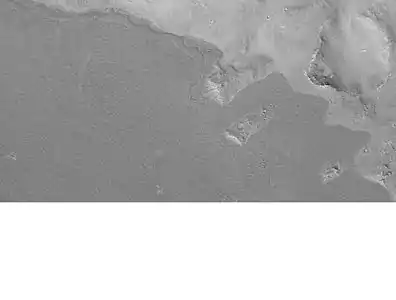 Lava flow in Elysium.  There are many lava flows in the Elysium quadrangle.  In this one, the lava flowed toward the upper right.  Image taken by Mars Global Surveyor, under the MOC Public Targeting Program.